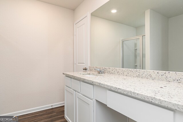 264 Oliver Dr, Locust Grove, GA 30248 - full bathroom featuring a shower stall, wood finished floors, vanity, baseboards, and recessed lighting