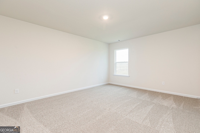 264 Oliver Dr, Locust Grove, GA 30248 - spare room featuring baseboards and light carpet