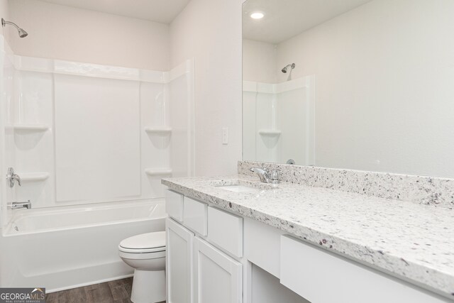 264 Oliver Dr, Locust Grove, GA 30248 - full bathroom with vanity, tub / shower combination, wood finished floors, toilet, and recessed lighting