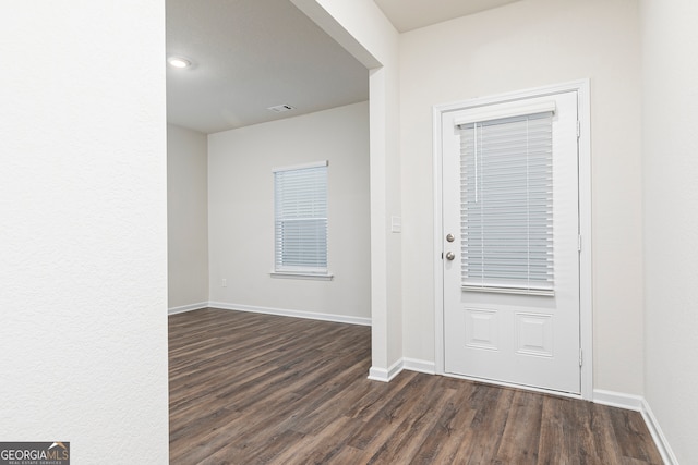 264 Oliver Dr, Locust Grove, GA 30248 - foyer entrance with dark wood-type flooring, baseboards, and visible vents