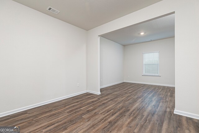 264 Oliver Dr, Locust Grove, GA 30248 - unfurnished room with dark wood-type flooring, baseboards, and visible vents
