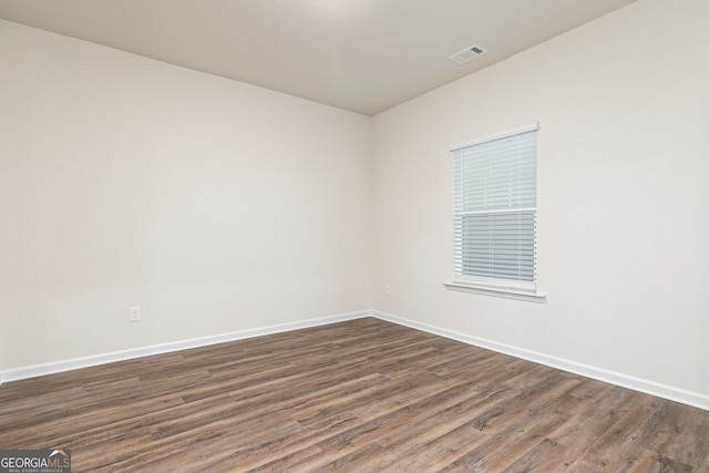 264 Oliver Dr, Locust Grove, GA 30248 - spare room with visible vents, dark wood-style flooring, and baseboards