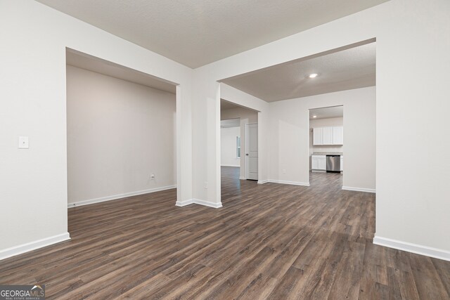 264 Oliver Dr, Locust Grove, GA 30248 - unfurnished living room featuring baseboards, recessed lighting, and dark wood-style flooring