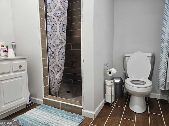 5655 Lake Forrest Dr NW, Atlanta, GA 30342 - bathroom with a stall shower, toilet, baseboards, and wood finished floors