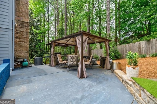 3389 Robinson Farms Trce NE, Marietta, GA 30068 - view of patio featuring a gazebo, fence, central AC unit, and outdoor dining area