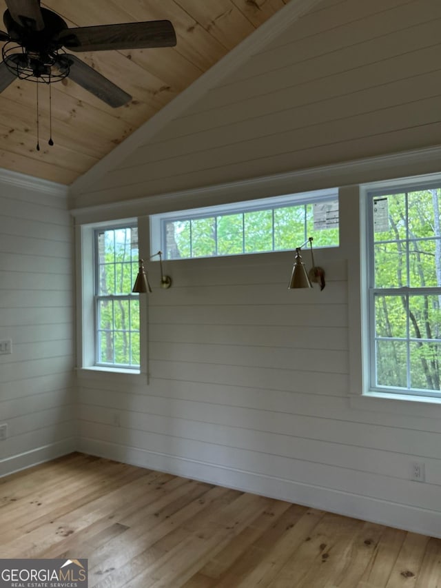 interior space with plenty of natural light, vaulted ceiling, and light wood-style flooring