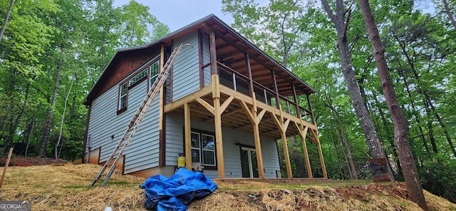 back of property with a wooden deck