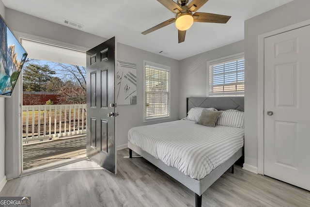 bedroom with access to outside, baseboards, visible vents, and light wood finished floors