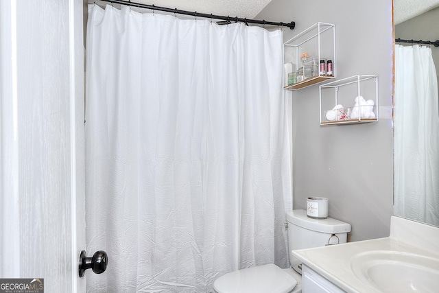 bathroom with toilet, a textured ceiling, a shower with curtain, and vanity