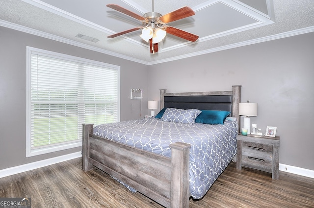 bedroom with crown molding, baseboards, visible vents, and wood finished floors