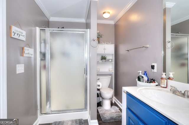 full bathroom featuring crown molding, toilet, a shower stall, and vanity