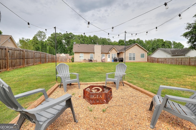 view of yard featuring a fenced backyard and an outdoor fire pit