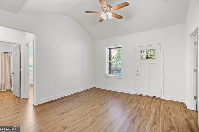 entryway featuring baseboards, a ceiling fan, light wood-style flooring, and lofted ceiling