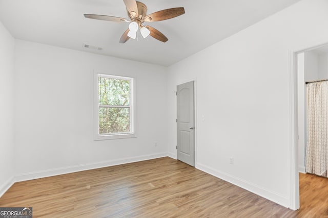 unfurnished bedroom with visible vents, a ceiling fan, light wood-style flooring, and baseboards