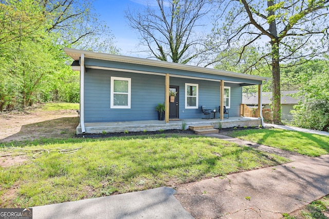 bungalow with a porch and a front lawn