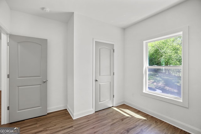 unfurnished bedroom featuring baseboards and wood finished floors