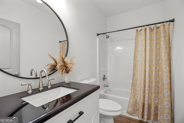 full bath with vanity, toilet, wood finished floors, and shower / tub combo with curtain