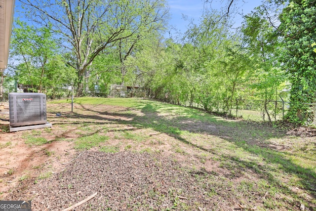 view of yard featuring central air condition unit and a fenced backyard