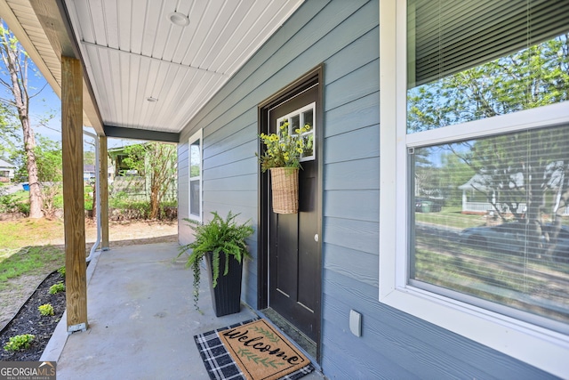 view of exterior entry with a porch