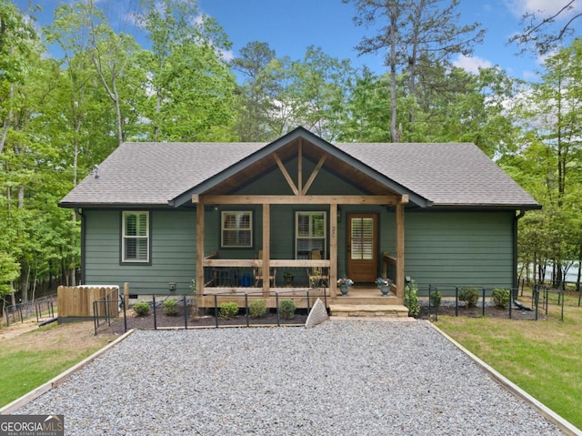 20 Mohawk Trl, Ellijay, GA 30540 - view of front of house featuring a shingled roof, a front lawn, fence, and covered porch