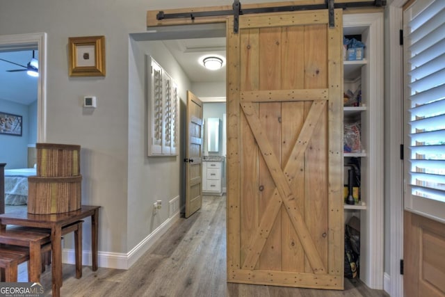 20 Mohawk Trl, Ellijay, GA 30540 - hallway with a barn door, baseboards, and wood finished floors
