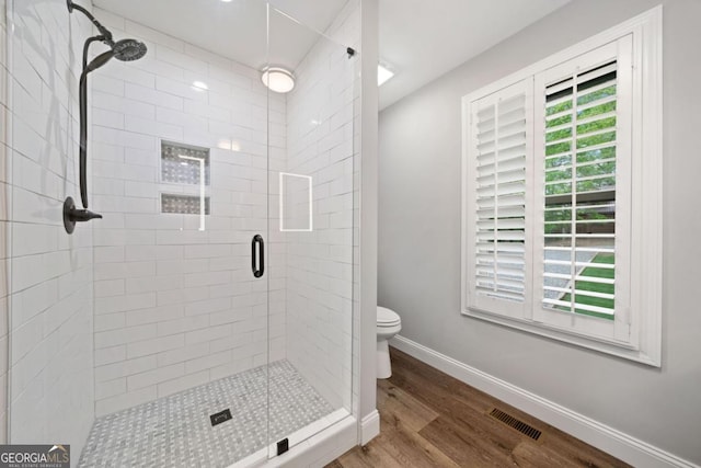 20 Mohawk Trl, Ellijay, GA 30540 - bathroom featuring toilet, baseboards, wood finished floors, visible vents, and a stall shower