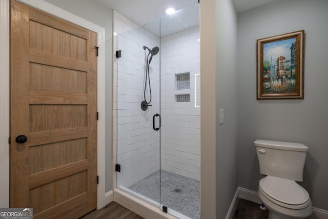 20 Mohawk Trl, Ellijay, GA 30540 - bathroom featuring toilet, baseboards, wood finished floors, and a stall shower
