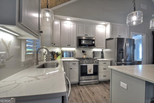 20 Mohawk Trl, Ellijay, GA 30540 - kitchen featuring a sink, pendant lighting, stainless steel appliances, and light wood-style flooring