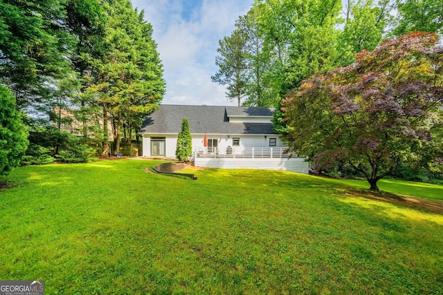 1007 Natalie Ln SE, Smyrna, GA 30082 - rear view of property featuring a lawn and a wooden deck