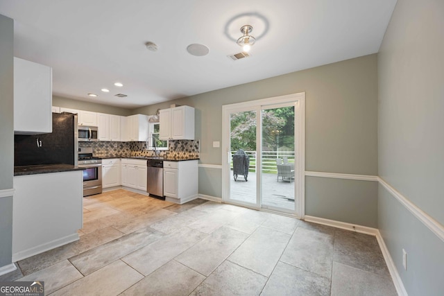 1007 Natalie Ln SE, Smyrna, GA 30082 - kitchen featuring appliances with stainless steel finishes, decorative backsplash, a sink, and visible vents