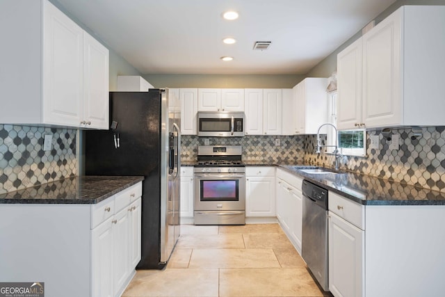 1007 Natalie Ln SE, Smyrna, GA 30082 - kitchen featuring a sink, appliances with stainless steel finishes, white cabinetry, and visible vents