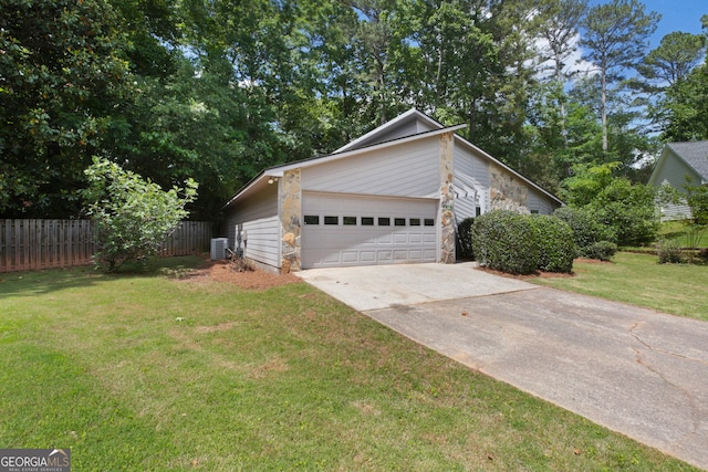 view of side of property featuring stone siding, driveway, and a garage
