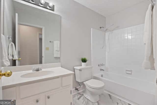 bathroom with toilet, vanity, shower / washtub combination, marble look tiles, and a textured ceiling