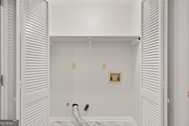 laundry room featuring hookup for a washing machine, marble finish flooring, and baseboards