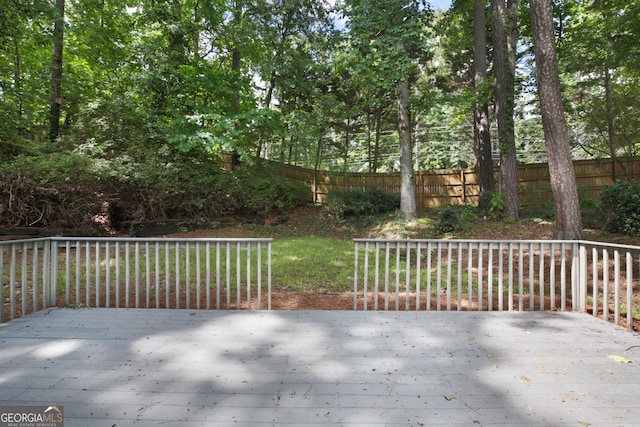 view of patio / terrace featuring a wooden deck and fence