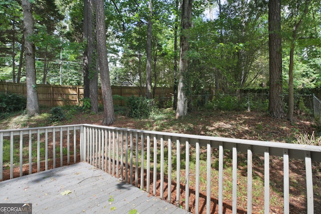 deck with a fenced backyard