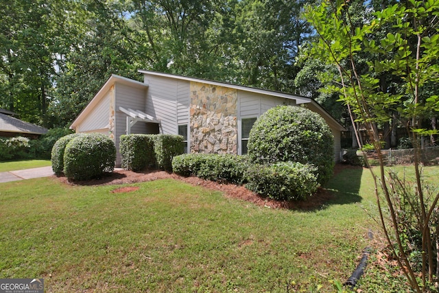 view of front of home with stone siding and a garage