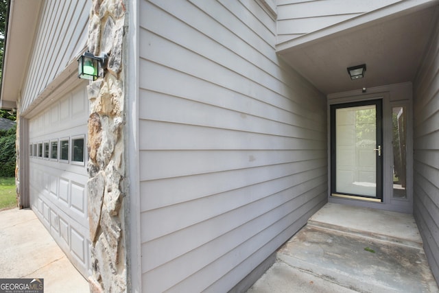 view of exterior entry with a garage