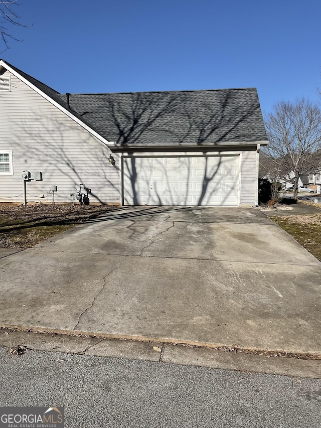 garage with concrete driveway