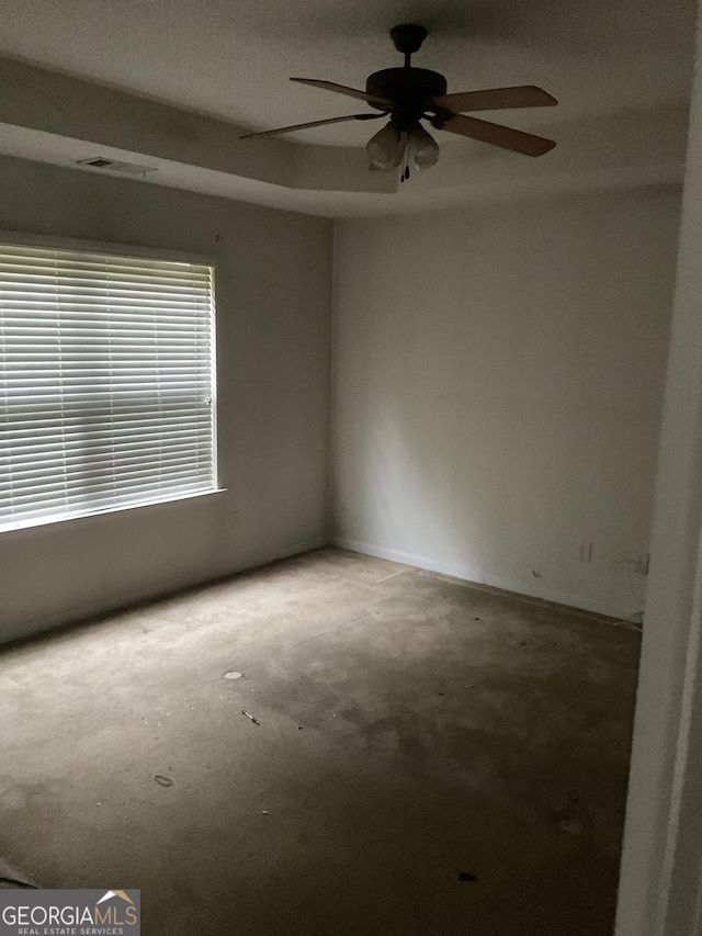 unfurnished room featuring a ceiling fan and visible vents