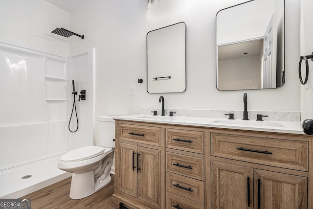full bathroom featuring a shower, a sink, wood finished floors, and toilet
