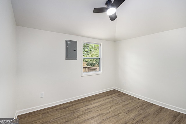 spare room featuring baseboards, electric panel, a ceiling fan, and wood finished floors