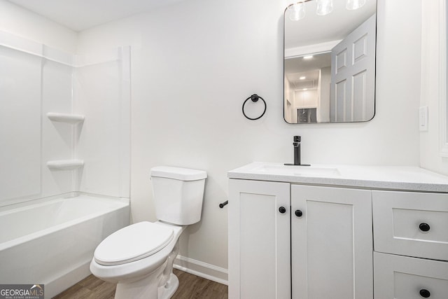 bathroom with shower / tub combination, wood finished floors, vanity, baseboards, and toilet