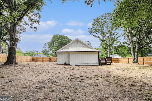 exterior space featuring a fenced backyard and a deck