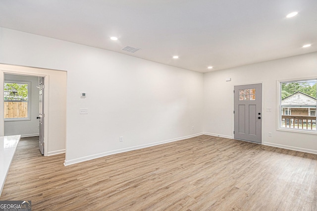 interior space with visible vents, light wood-style floors, and baseboards