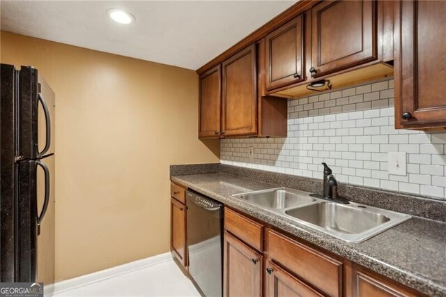 3135 Reeves St SE, Smyrna, GA 30080 - kitchen with dark countertops, a sink, dishwasher, freestanding refrigerator, and backsplash