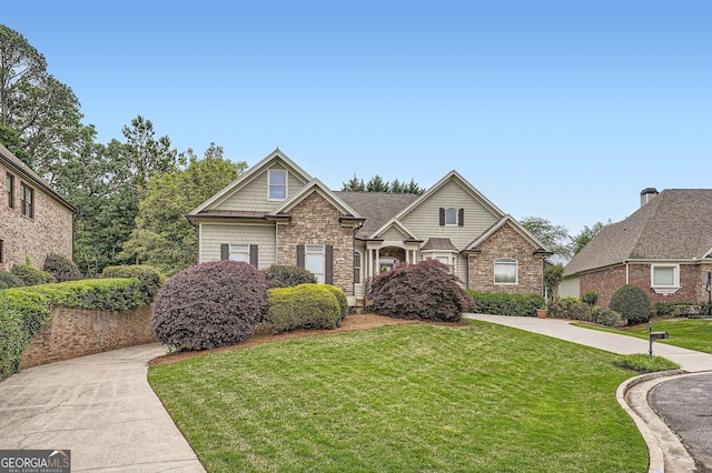 view of front of home with stone siding and a front yard