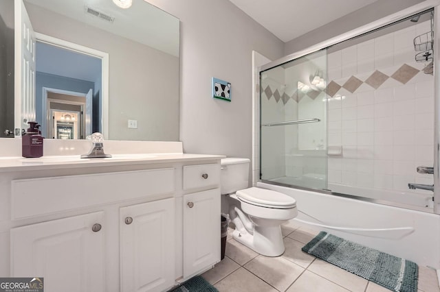full bathroom featuring toilet, vanity, visible vents, tile patterned flooring, and enclosed tub / shower combo