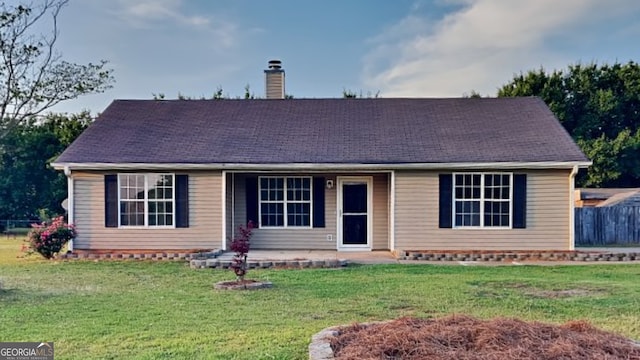 943 Colvin Dr, Locust Grove, GA 30248 - single story home with fence, a front yard, and a chimney