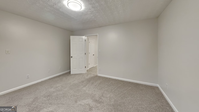 943 Colvin Dr, Locust Grove, GA 30248 - carpeted spare room with a textured ceiling and baseboards